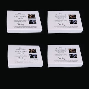 May include: Four white boxes with a black border and a picture of doves on the front. The boxes are labeled "The Home Alone 2 Friendship Doves" and have a quote from the movie. The boxes are made in the USA.