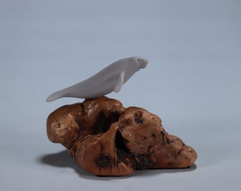 Manatee Sculpture by John Perry Airbrushed 3 inches long on polished burlwood base.