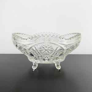 Oval crystal footed bowl with sawtooth rim | Vintage crystal bowl with decorative floral detail | Crystal display basket on glass feet