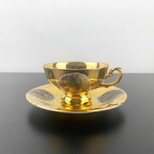 Du-Co Kunst Rehau Bavaria gold tea cup and saucer with hand painted Victorian scenes | German antique gold cup and saucer