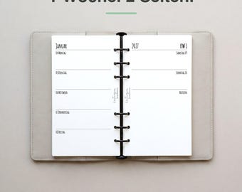 May include: An open planner with a black six-ring binder mechanism, featuring white pages with the text 1 Woche. 2 Seiten. at the top. The pages display the month of January 2027, week 1, with daily entries from Monday to Sunday and a notes section.