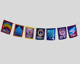 May include: A colorful banner of seven square flags strung together. Each flag features a unique design, including a rainbow, a crescent moon, a candle, a peace symbol, bamboo, a lotus flower, and a dove. The word "Peace" is written on several flags.