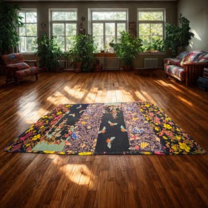 May include: A rectangular quilt featuring a patchwork design with vertical panels. The fabric displays a black background with colorful floral patterns, intricate geometric motifs, and small insect illustrations in shades of yellow, red, and blue.