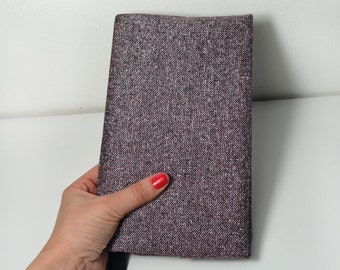 Adjustable glitter fabric book cover.