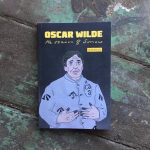 A copy of Oscar Wilde: The Season of Sorrow on a weathered table with the front cover viewed from above.