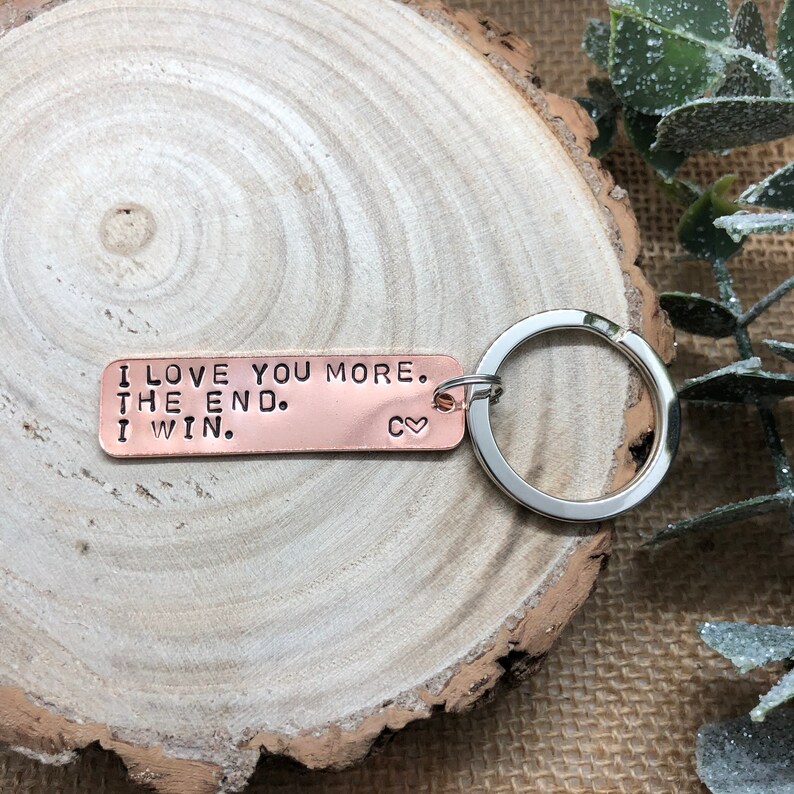 May include: Copper keychain with the text "I love you more. The end. I win." and a small heart symbol.