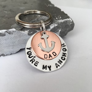 May include: Silver and copper keychain with an anchor charm and the text "You're My Anchor Dad".