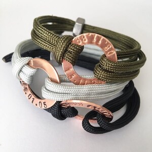 May include: Three braided rope bracelets with copper rings. The rings have engraved numbers, including "68 71 80" and "13.11.04.01.05".