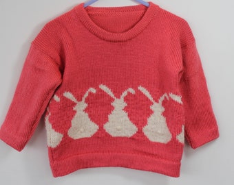 Pretty little bunny jumper for a one year old girl in coral pink. Wooden rabbit buttons, spring wear, gift idea.