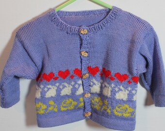 Woolly spring cardigan for a 6-9 m baby girl. Knitted in a violet tone, with hearts , rabbits and yellow flowers, wooden rabbit buttons.