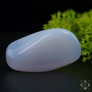 Pode incluir: Uma gema polida, oval, lisa e azul p&aacute;lida.