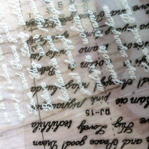 May include: A close-up of a clear sheet of paper with white lettering on top of a sheet of paper with black lettering. The white lettering says "Love and Peace good! Dream" and "Love Hug Lovely techinh" and "Love and Peace good! Dream". The black lettering says "Good! Amazing! ndagu" and "ham cie pink pigna" and "we and Peace" and "saya sayang kamu".