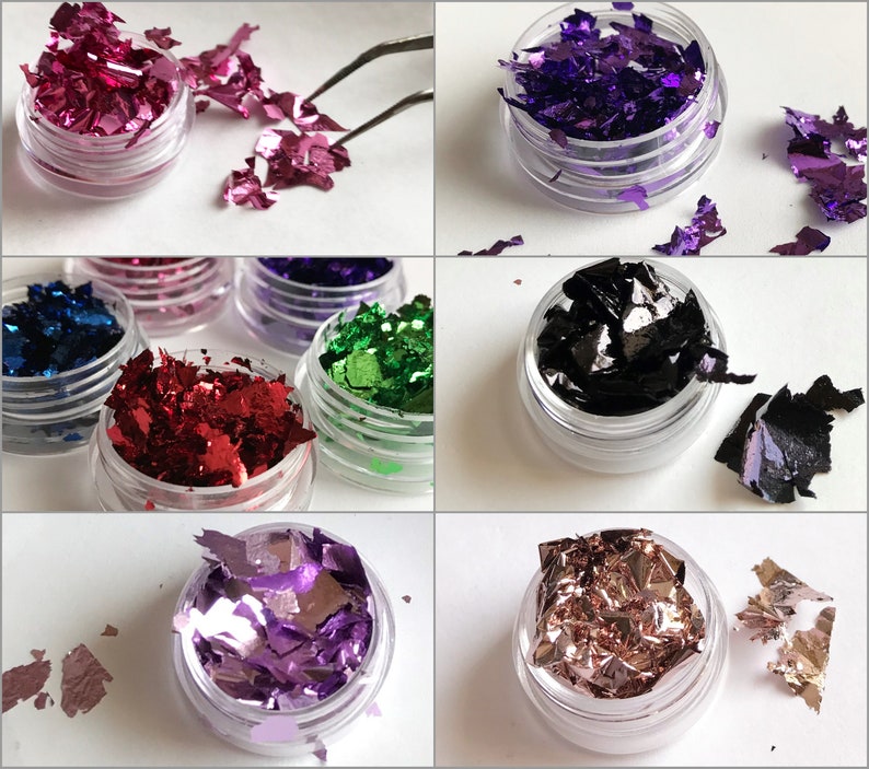 May include: Assortment of small jars filled with colorful metallic flakes. The flakes are in various shades of pink, purple, green, red, black, and gold. The jars are clear plastic with a screw-on lid.
