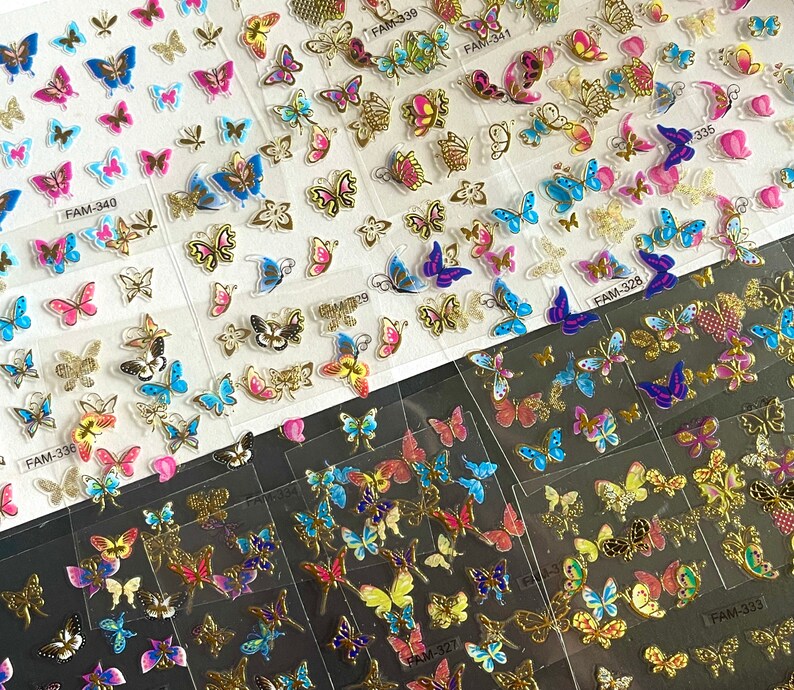 May include: A sheet of clear nail stickers with colorful butterfly designs. The stickers are arranged in rows and columns, with each butterfly design unique. The stickers are perfect for adding a touch of whimsy to your nails.