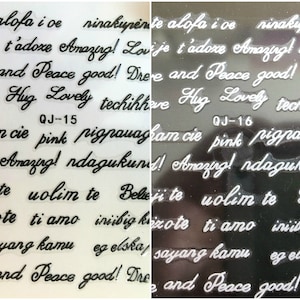 May include: Two sheets of clear sticker paper with black lettering. The stickers feature phrases in multiple languages, including "Amazing!" and "Peace good!" The sheets are labeled "QJ-15" and "QJ-16".