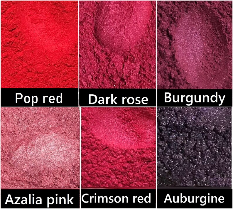 May include: Six small containers of red, pink and purple pigment powder. The containers are labelled "Pop red", "Dark rose", "Burgundy", "Azalia pink", "Crimson red", and "Aubergine".