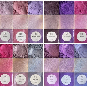May include: A collection of 12 small jars of purple, pink, and blue mica powder. Each jar has a white label with the name of the color and "DD" printed on it. The jars are arranged in a grid of four rows and three columns.
