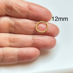 May include: A gold-colored, textured, 12mm hoop earring.
