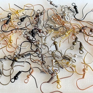May include: A large assortment of earring hooks in various finishes, including silver, gold, and bronze. The hooks are made of metal and have a spring-loaded closure.