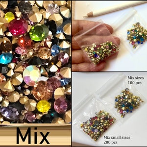 May include: Two bags of colorful rhinestones in various sizes. The bag on the left contains 200 pieces and the bag on the right contains 100 pieces.  The text on the image reads "Mix small sizes 200 pcs" and "Mix sizes 100 pcs".
