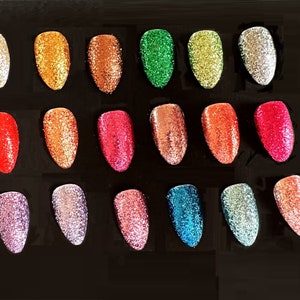 May include: A collection of 18 small jars of glitter in various colors, including red, green, blue, gold, silver, and pink. The glitter is arranged in a grid pattern on a black background.