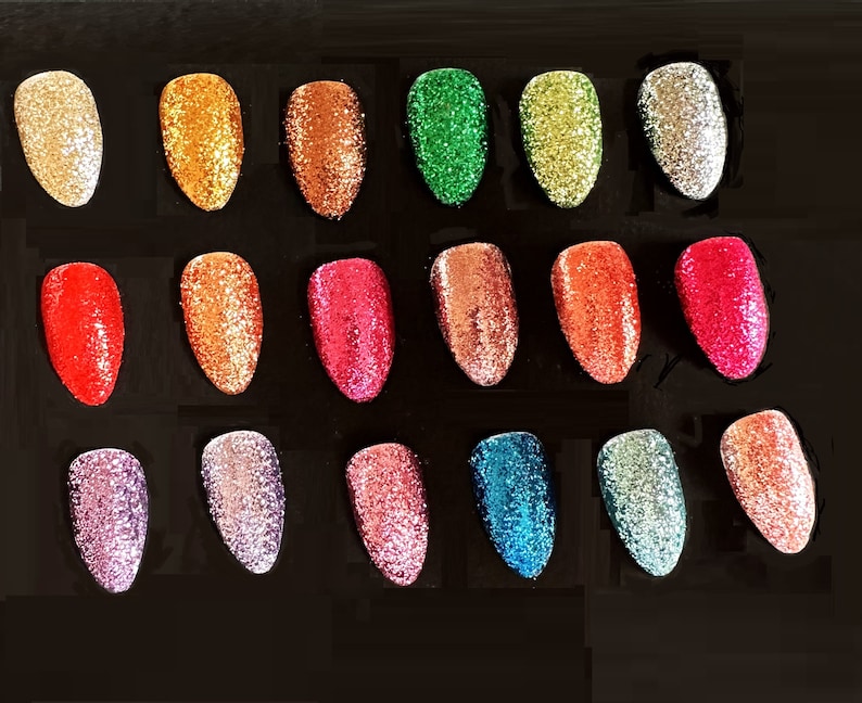 May include: A collection of 18 small jars of glitter in various colors, including red, green, blue, gold, silver, and pink. The glitter is arranged in a grid pattern on a black background.