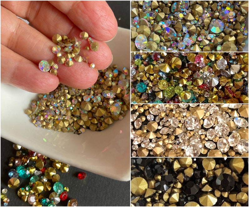 May include: Assortment of colorful rhinestones in various sizes and shapes. The rhinestones are displayed in a white bowl and on a black surface. The rhinestones are perfect for crafting, jewelry making, and decorating.