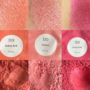 May include: Three small jars of loose powder pigment in shades of red, pink, and orange. The jars are labeled with the text "DD" and the names of the colors: "Indian Red", "Salmon", and "Deep Pink". Each jar contains 5 grams of pigment.
