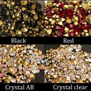 May include: Four close-up images of different colored rhinestones. The first image shows black rhinestones with gold accents. The second image shows red rhinestones with gold accents. The third image shows iridescent rhinestones with gold accents. The fourth image shows clear rhinestones with gold accents.