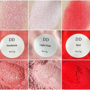 May include: Three eyeshadow samples in shades of red, pink, and light pink. The samples are labeled "DD Firebrick", "DD Light Pink", and "DD Red". Each sample is 5 grams.