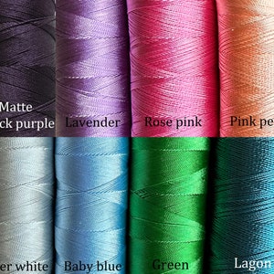 May include: Eight spools of embroidery floss in various colors, including matte black purple, lavender, rose pink, pink peach, silver white, baby blue, green, and lagoon.