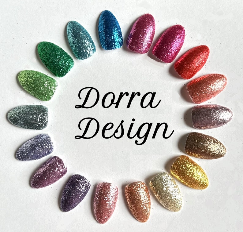 May include: A variety of glitter nail polish colors arranged in a circle. The colors include green, blue, purple, pink, red, gold, silver, and more. The text "Dorra Design" is in the center of the circle.