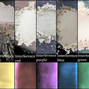 May include: Five samples of interference pigments in powder form. The colors are gold, red, purple, blue, and green. The pigments are shown on a black background. Below the samples are swatches of the colors in their finished form.