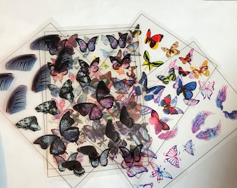 May include: Assortment of colourful butterfly stickers on clear sheets. The stickers feature various butterfly designs, including wings, full butterflies, and abstract butterfly shapes.