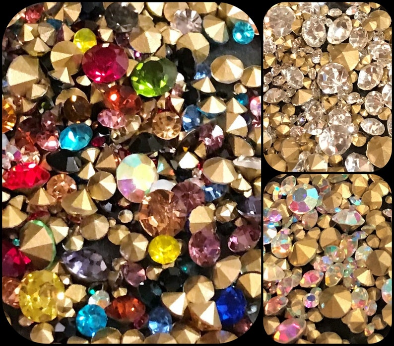 May include: Assortment of colorful and clear rhinestones with gold settings. The rhinestones are in various shapes and sizes.