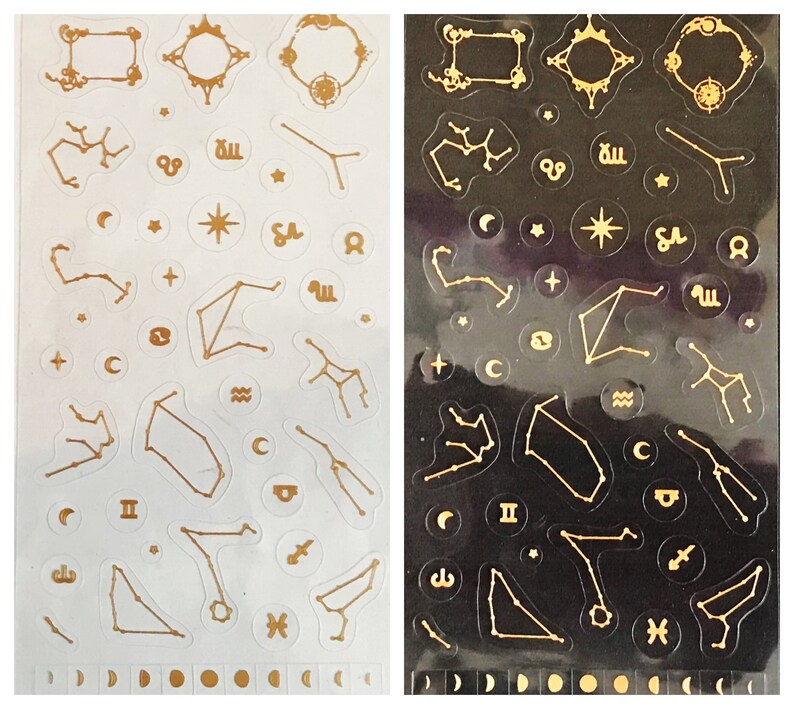 May include: Two sheets of gold constellation stickers, one on a white background and one on a black background. The stickers feature various constellations, stars, and celestial symbols.