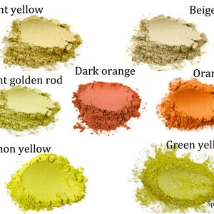 May include: Six small piles of loose powder pigment in various shades of yellow, orange, and beige. The colors are labeled "Light yellow", "Light golden rod", "Lemon yellow", "Green yellow", "Beige", "Dark orange", and "Orange".