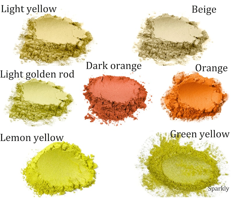May include: Six small piles of loose powder pigment in various shades of yellow, orange, and beige. The colors are labeled "Light yellow", "Light golden rod", "Lemon yellow", "Green yellow", "Beige", "Dark orange", and "Orange".