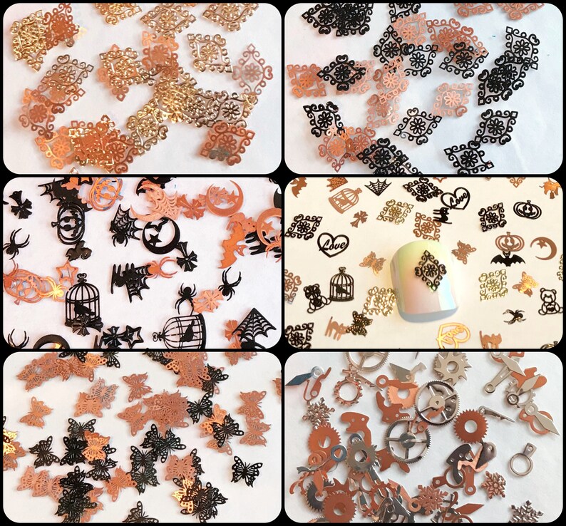 May include: Assortment of small metal charms in various shapes and designs, including butterflies, cages, gears, and gothic-inspired patterns. The charms are in gold, black, and copper tones.