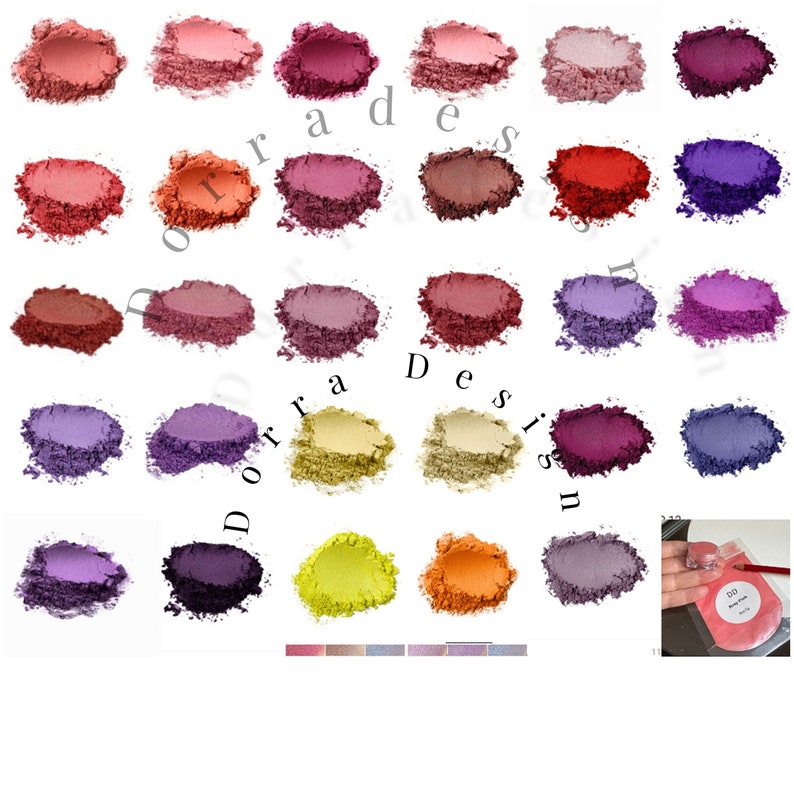 May include: Assortment of 20 small round containers filled with various shades of purple, pink, red, orange, yellow, and brown powder. The powder is likely mica powder used for crafting and cosmetic purposes.