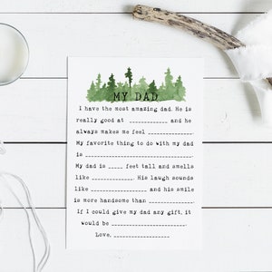 May include: A printable fill-in-the-blank card with a watercolor illustration of a forest. The card says "My Dad" and has prompts for writing about a father. The text includes: "I have the most amazing dad. He is really good at ______ and he always makes me feel ______. My favorite thing to do with my dad is ______. My dad is ______ feet tall and smells like ______. His laugh sounds like ______ and his smile is more handsome than ______. If I could give my dad any gift, it would be ______. Love, ______."