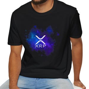 May include: Black t-shirt with a white XRP logo on a blue and purple galaxy background.