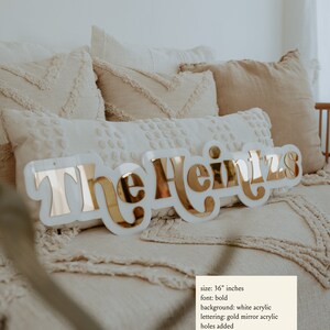 Last Name Sign shown in white and gold mirror acrylic.