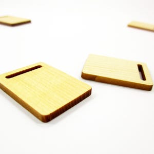 Realistic 1:12 scale miniature wooden cutting boards for bakery displays, handcrafted with natural wood grain for dioramas.