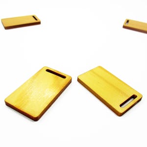 Set of two handcrafted 1:12 scale miniature long wooden cutting boards, size 23x38mm, for dollhouse kitchen display scenes.
