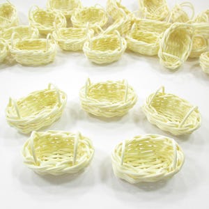 Group of five 1:12 scale handcrafted oval baskets with two handles, ideal for Easter dioramas or miniature wedding displays.