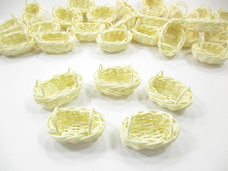 Group of five 1:12 scale handcrafted oval baskets with two handles, ideal for Easter dioramas or miniature wedding displays.