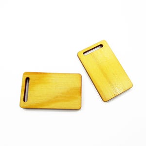 Set of two miniature 1:12 wooden cutting boards 23x38 mm shown together for scale dollhouse food displays and dioramas.