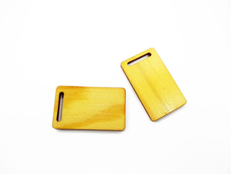 Set of two miniature 1:12 wooden cutting boards 23x38 mm shown together for scale dollhouse food displays and dioramas.