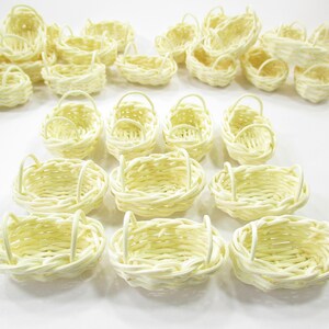 Bulk collection of handcrafted 1:12 scale oval wicker baskets arranged to showcase consistent size and traditional rustic style.